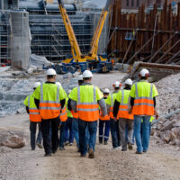 Construction workers walking to work site Construction workers walking to work site