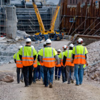 Construction workers walking to work site Construction workers walking to work site