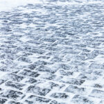 Cobblestone sidewalk covered with ice and snow Cobblestone sidewalk covered with ice and snow