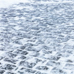 Cobblestone sidewalk covered with ice and snow Cobblestone sidewalk covered with ice and snow
