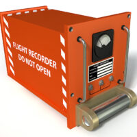 Red airplane black box that say flight recorder do not open