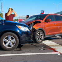 Serious car wreck at intersection due to wrong-way driving