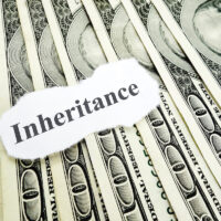 Inheritance note on top of hundred dollar bills