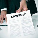 lawyer passes lawsuit document to camera lawyer passes lawsuit document to camera