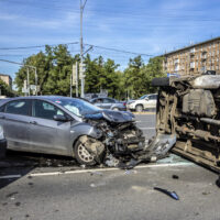 Accident involving an overturned ambulance ranning into a car and rolled over