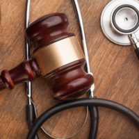 Stethoscope and gavel on courtroom table. Stethoscope and gavel on courtroom table.