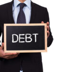 Guy holding debt sign Guy holding debt sign