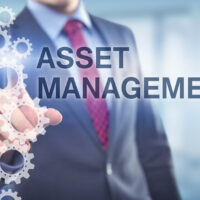 Businessman points at Asset Management caption