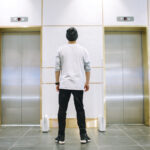 Man in hat waiting for an elevator Man in hat waiting for an elevator