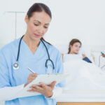 A Nurse filling out a chart A Nurse filling out a chart