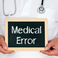 Doctor holding a medical error sign