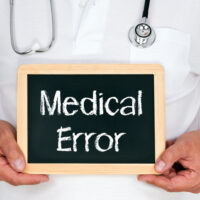 Doctor holding a medical error sign Doctor holding a medical error sign