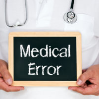 Doctor holding a medical error sign Doctor holding a medical error sign