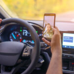 Male driver using smartphone to to take selfie while driving Male driver using smartphone to to take selfie while driving