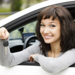 Young female in car holding her car keys Young female in car holding her car keys