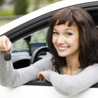 Young female in car holding her car keys