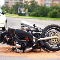 motorbike flipped sideways on ground after accident