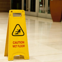 Caution Wet Floor signage in lobby Caution Wet Floor signage in lobby