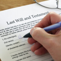 Man filling out his Will form.jpg.crdownload