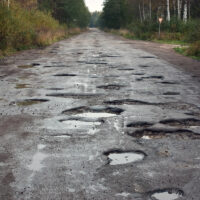 many potholes on road show poor conditions