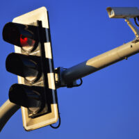 Red light camera and Traffic lights over the blue sky Red light camera and Traffic lights over the blue sky