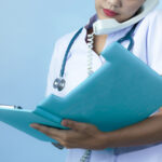 female-physician-holding-a-file female-physician-holding-a-file