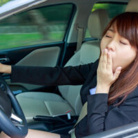 Girl yawning while driving Girl yawning while driving