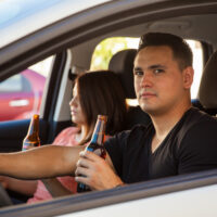 teenage couple drinkin while driving