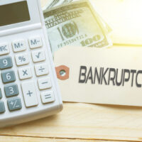 Calculator and bankruptcy sign