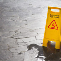 slip and fall sign next to wet floor