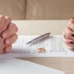 Couple signing Divorce papers Couple signing Divorce papers