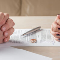 Couple signing Divorce papers Couple signing Divorce papers