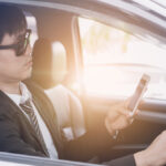 A business man on phone while driving A business man on phone while driving
