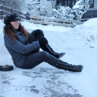 a girl slips on a trail in the snow