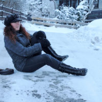 a girl slips on a trail in the snow a girl slips on a trail in the snow