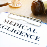Clipboard with documents about medical negligence on a table