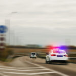 Police car chasing the offender at high speed on the highway . Police car chasing the offender at high speed on the highway .