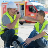 manager calling for help for construction worker injured at work manager calling for help for construction worker injured at work