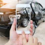 female hold mobile smartphone photographing car accident female hold mobile smartphone photographing car accident