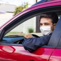 Young driver with face mask Young driver with face mask