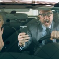 accident in car . man and woman using cellphone while driving car accident in car . man and woman using cellphone while driving car