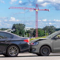Minor car accident of two cars. Car crash on city road. Damage to passenger car Minor car accident of two cars. Car crash on city road. Damage to passenger car