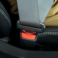 Car safety concept. Passenger sitting in car seat and wearing seat belt. Car safety concept. Passenger sitting in car seat and wearing seat belt.