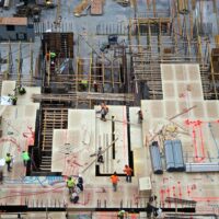 Aerial view of men and materials during construction of a new high-rise apartment building in midtown Manhattan, New York City.