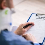 Man Hand Filling The Slip And Fall Injury Report